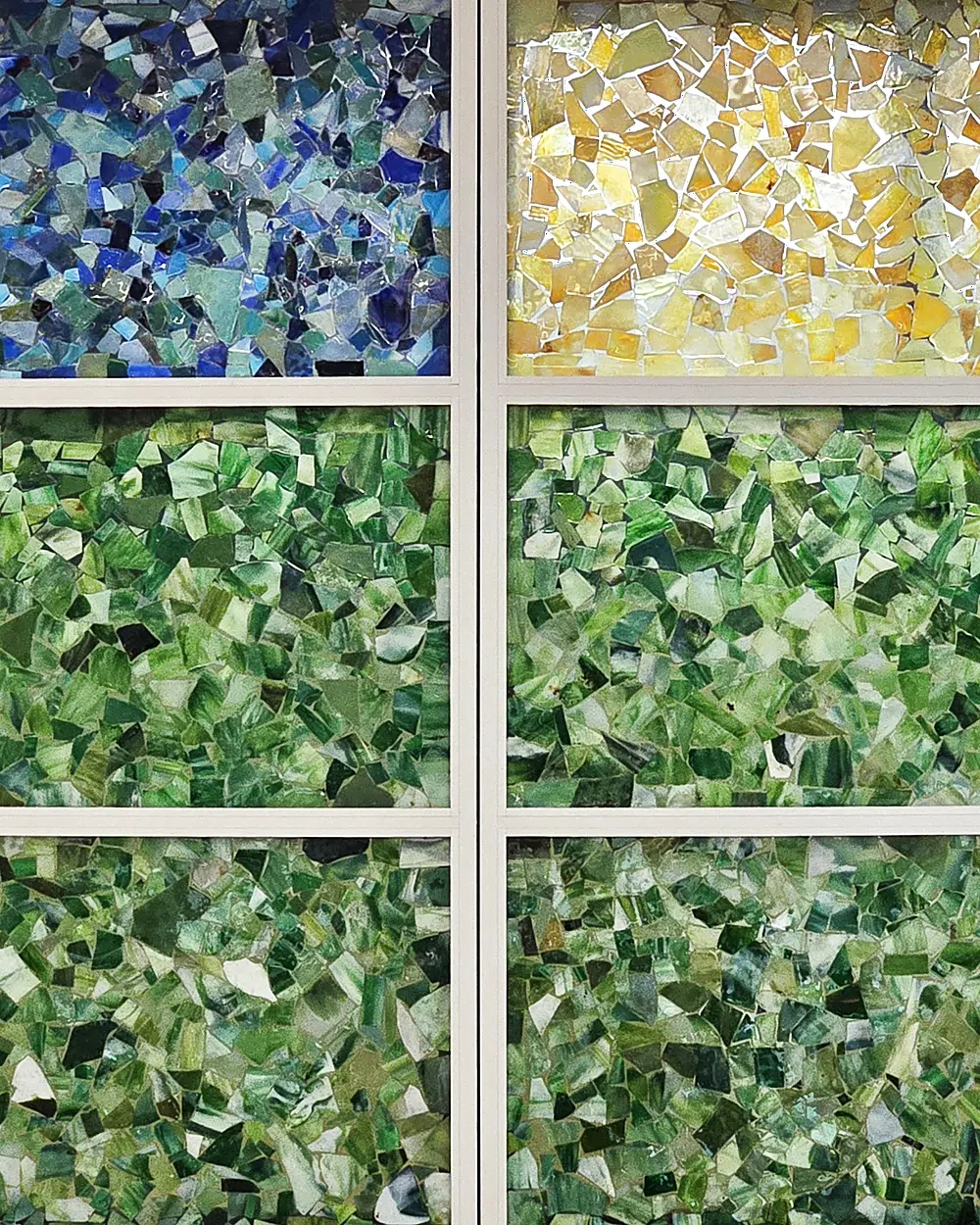 Close-up of the stained-glass mosaic windows that give the Tiffany School its name, in blues, golds and greens